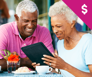 An elderly couple looking at their financial portfolio over desert