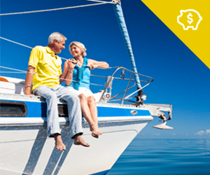 An elderly couple sitting on a sailboat