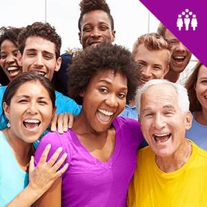 A varied group of people standing together smiling