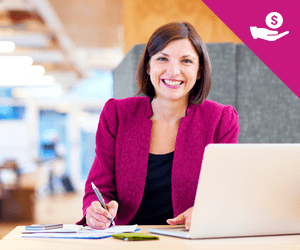 A professional woman sitting at a desk in front of a laptop