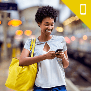 A young woman standing and holding a smart phone